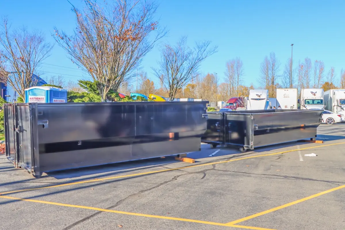 Professional dumpster rental service with roll-off container on residential driveway in Salton City